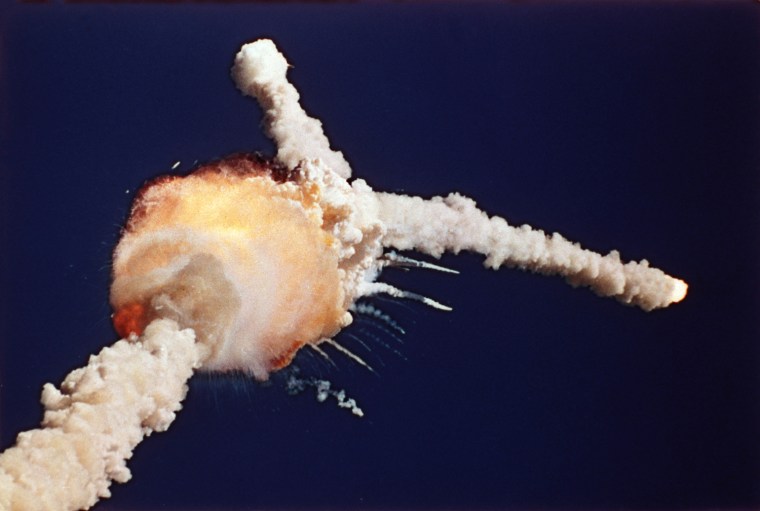 Image: An orange fireball marks the explosion of the space shuttle Challenger