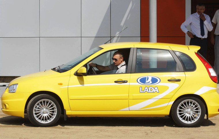 Image: Russia's Prime Minister Vladimir Putin drives a Russian-made Lada Kalina car