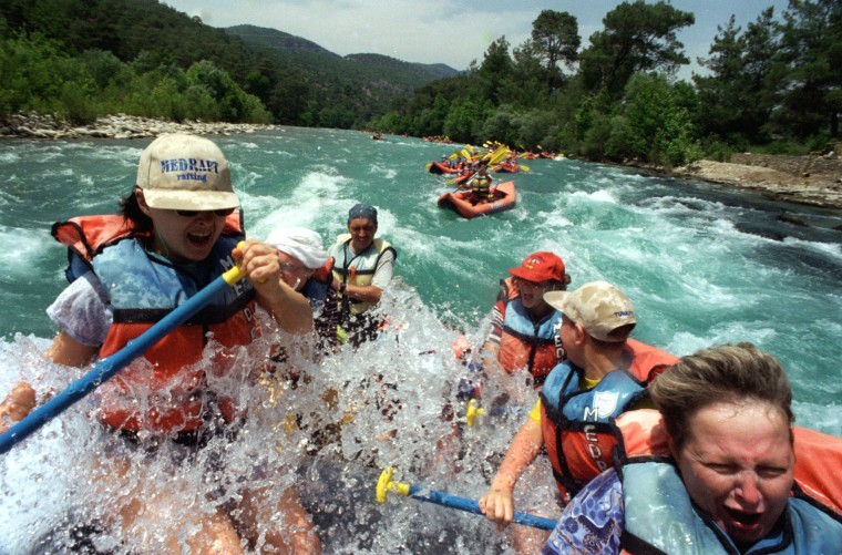 Image: Russian tourists enjoying white-water rafting