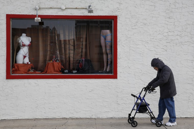 Image: A man pushing a walking aid