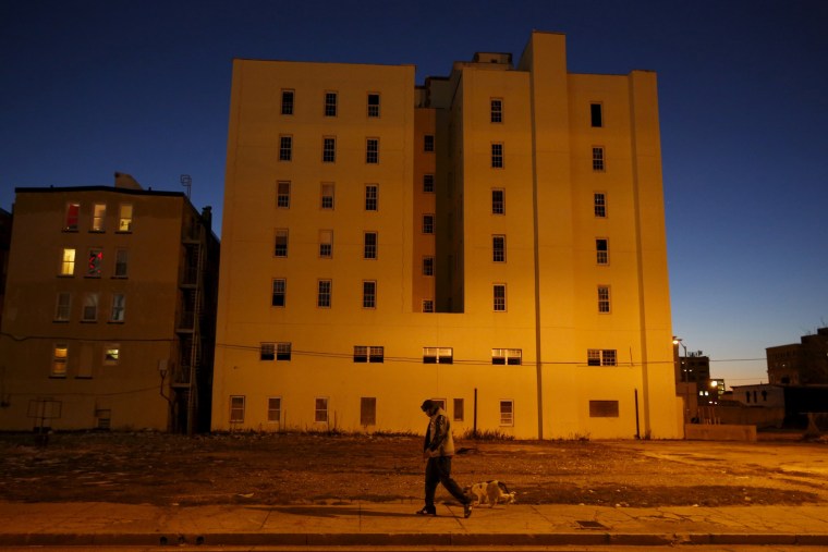 Image: A man walks with a dog