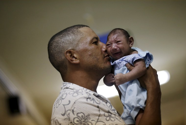Image: Geovane Silva holds his son Gustavo Henrique, who has microcephaly.