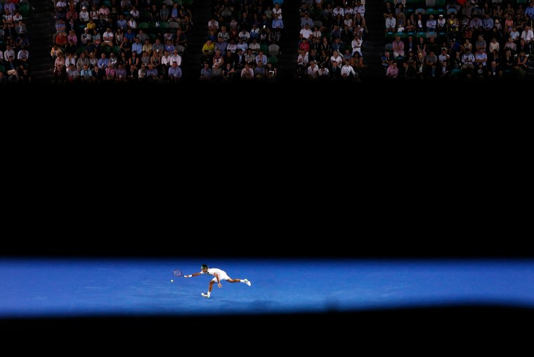 Image: Switzerland's Federer stretches for a shot during his third round match against Bulgaria's Dimitrov