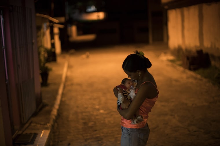 Image: Santos holding baby