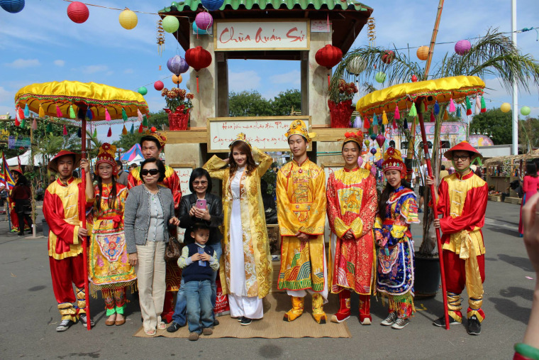 The UVSA Tet Festival royal court pose in front of a recreation of a Vietnamese temple.