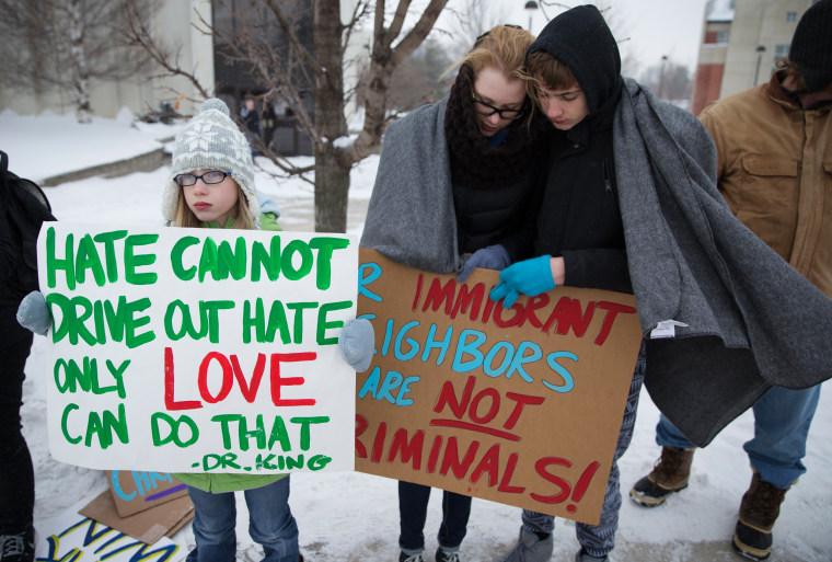 Image: People protest outside a Trump campaign rally in Iowa