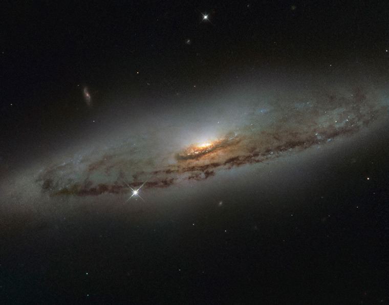 Image: The spiral galaxy NGC 4845, located over 65 million light-years away in the constellation of Virgo in NASA/ESA Hubble Space Telescope image