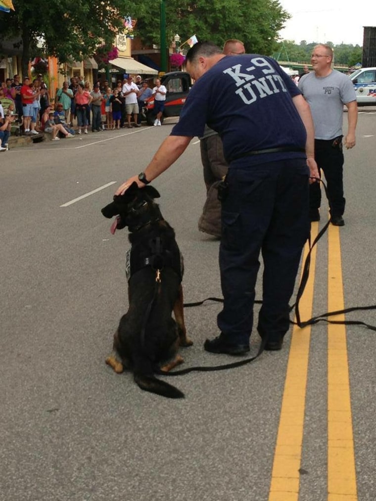 Ajax gets a pat from his handler, Marietta police Officer Matthew Hickey.