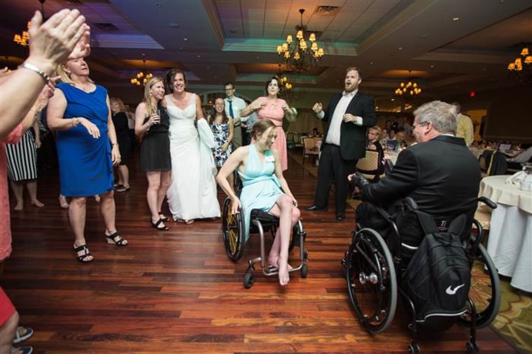 Paul Martin, in wheelchair, dances at his daughter's wedding as bride Brittany Dejean (in background) looks on.