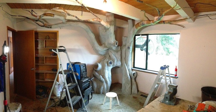 Rob Adams paints the tree from handmade magical fairy forest.