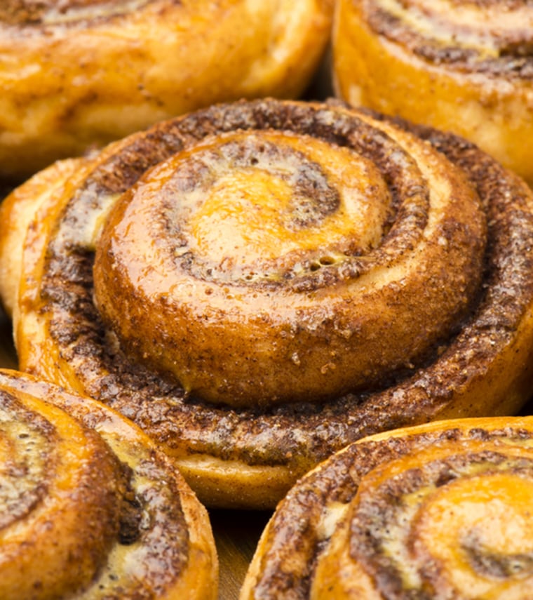 Homemade cinnamon buns as background.