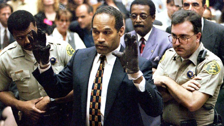 O.J. Simpson holds up his hands to the jury wearing the infamous gloves found at the crime scene and his home during his murder trial.