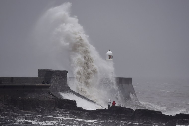 Image: Waves crash over the lighthouse at Porthcawl, Wales