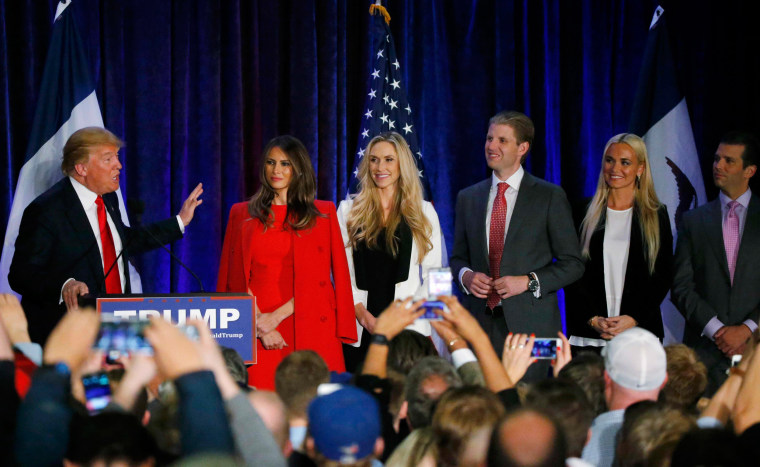 Image: Republican Presidential Candidate Donald Trump speaks with his family onstage at caucus night rally in Des Moines, Iowa