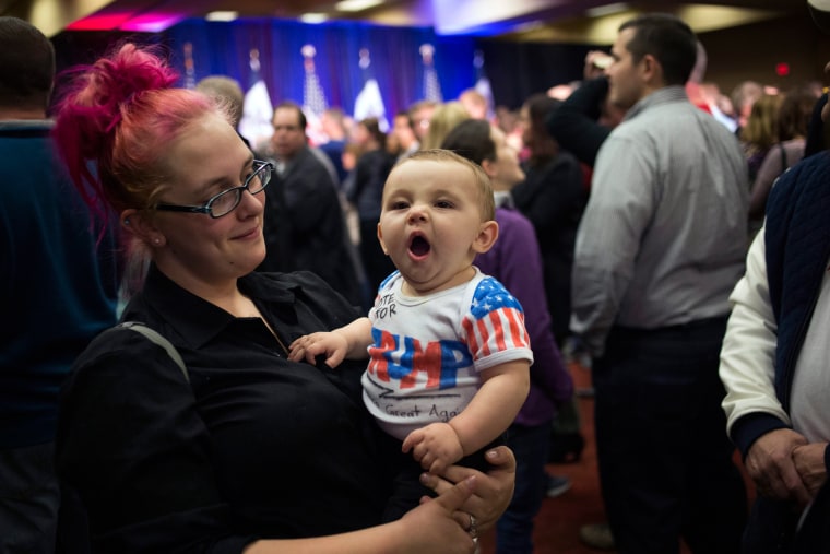 Image: A mother and her baby arrive to support U.S. Republican presidential candidate Donald Trump