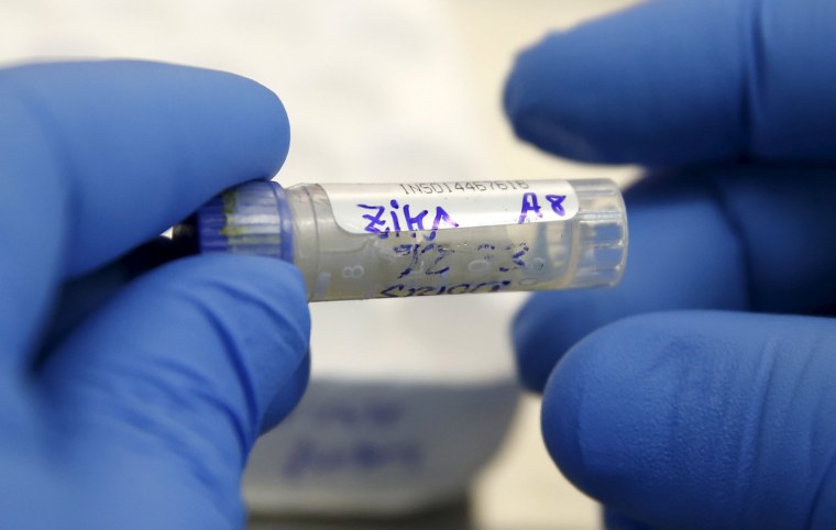 Image: A health technician analyzes a blood sample from a patient bitten by a mosquito at the National Institute of Health in Lima