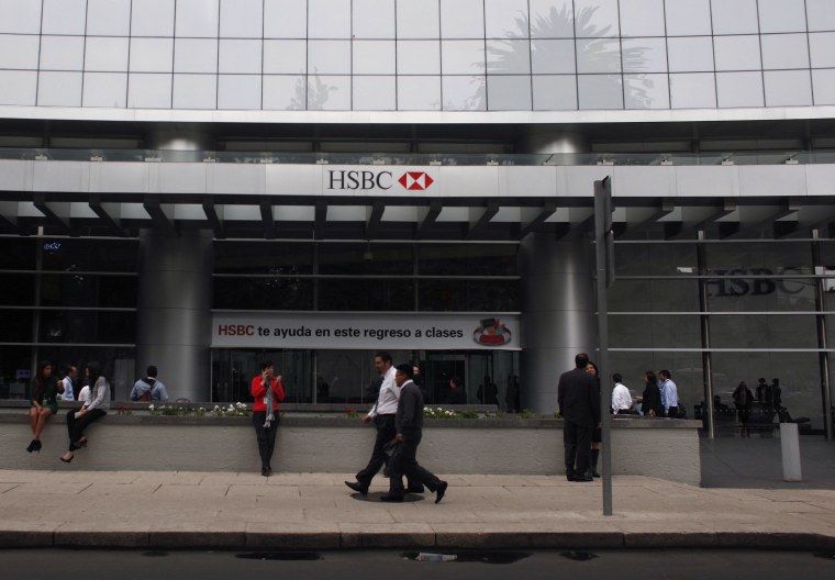 Image: Pedestrians walk past the entrance of British bank HSBC's headquarters in Mexico City