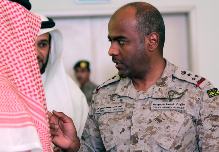 Image: Saudi military spokesman Ahmed Asiri, right, talks to Saudi officials