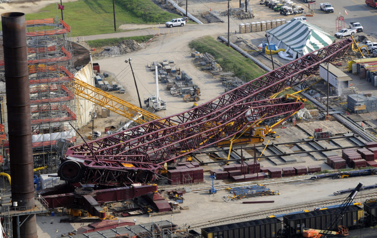 Image: A collapsed crane is visible within the LyondellBasell Houston Refinery on July 18, 2008 in Houston.
