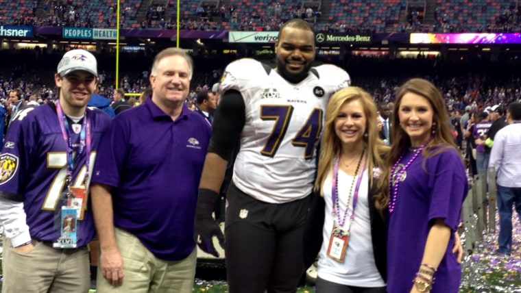 The Tuohy family celebrate together on the field after Michael's 2013 Super Bowl win with the Baltimore Ravens.