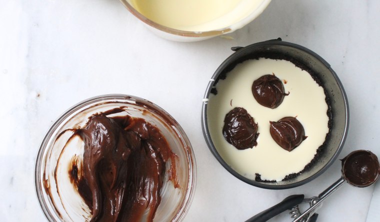 Slow Cooker Marble Cheesecake: Pour half of the vanilla batter into the pan and dollop half of the chocolate batter