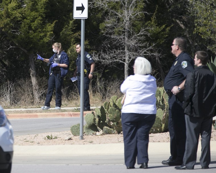 Image: Austin Police Department officers investigate the scene of an officer involved shooting