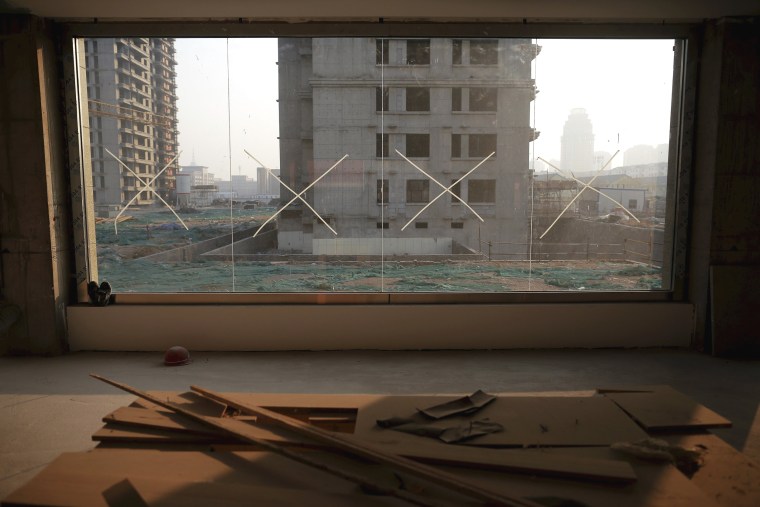 Image: The construction site of Zixia Garden development complex is seen from inside an unfinished building in Qianan, Tangshan City