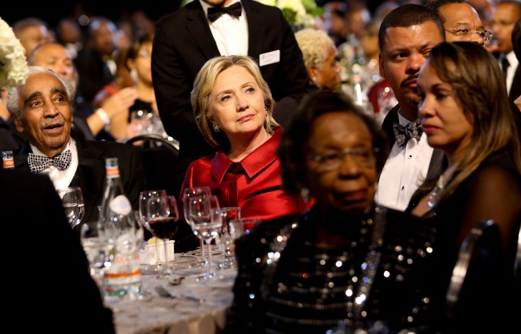 Image: Democratic presidential candidate Hillary Clinton listens to a speaker