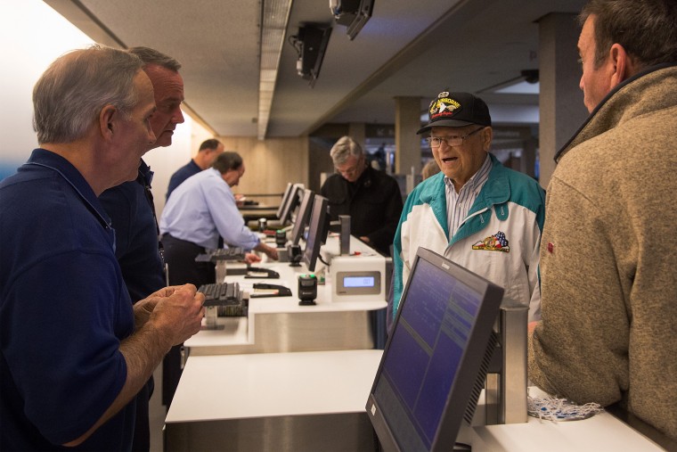 Image: Norwood Thomas, a 93-year-old World War II veteran, answers a question from airline employees