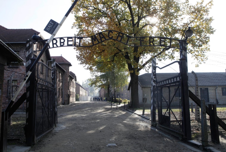 Image: The entrance  with the inscription "Arbeit Macht Frei" (Work Sets You Free) gate of the former German Nazi death camp of Auschwitz