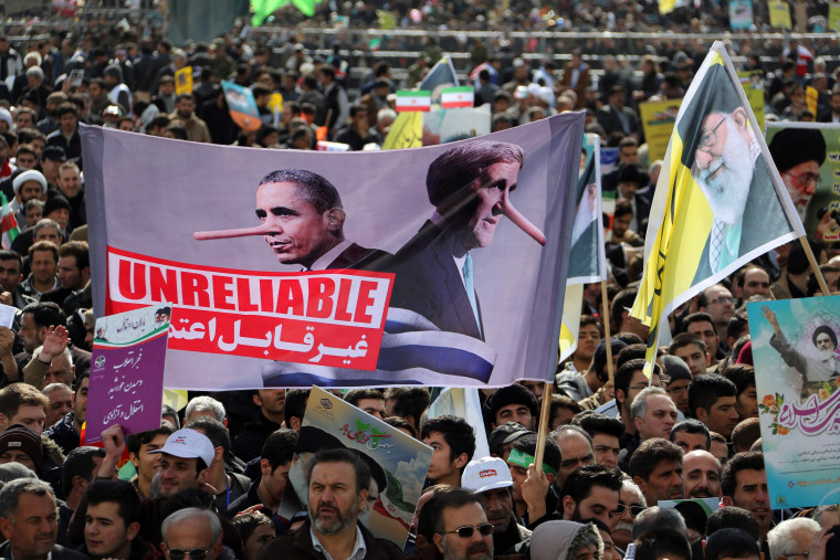 Image: Iranians hold placards during celebrations in Tehran's Azadi Square Thursday.