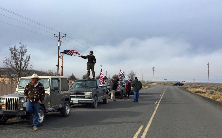 Image: People wave American flags near the Malheur National Wildlife Refuge
