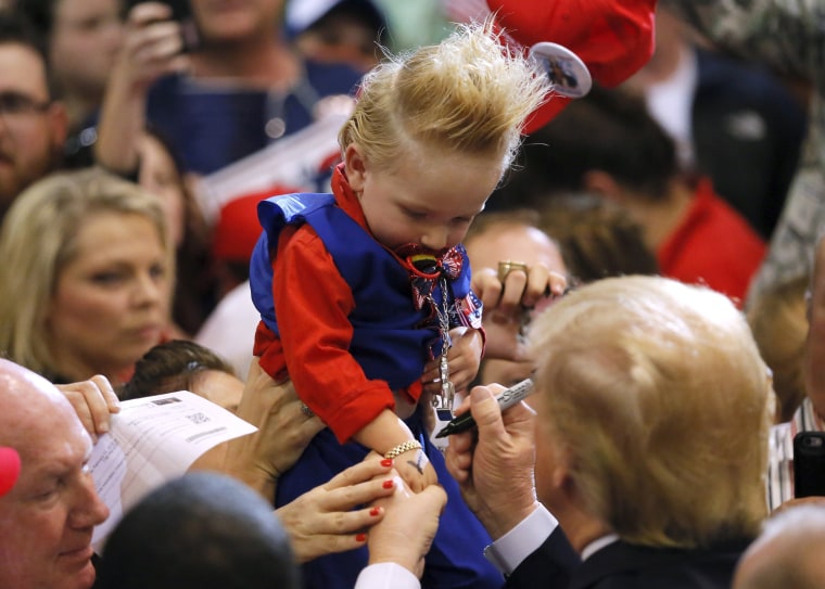 Image: Republican U.S. presidential candidate Donald Trump signs the arm of 19-month-old Curtis Ray Jeffery II after a rally in Baton Rouge, Louisiana