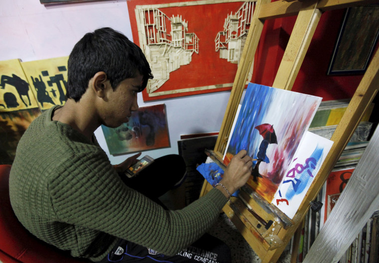 Image: An orphan boy draws at the Iraqi Safe House for Creativity in Baghdad