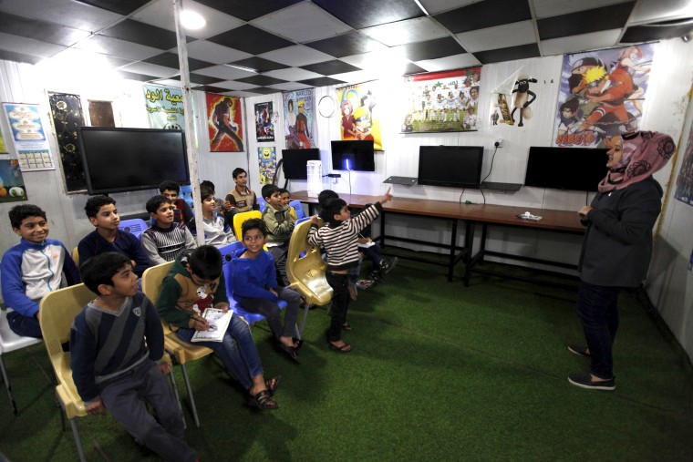 Image: A teacher gives a lesson to orphans boys at the Iraqi Safe House for Creativity in Baghdad