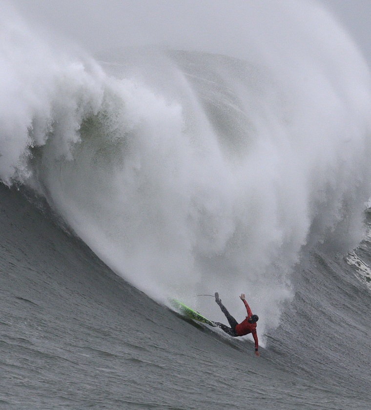 Image: Jamie Mitchell wipes out on a giant wave during the finals of the Mavericks surfing contest
