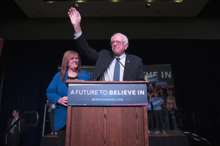 Image: Sen. Bernie Sanders waves after arriving for a canvass kick-off event