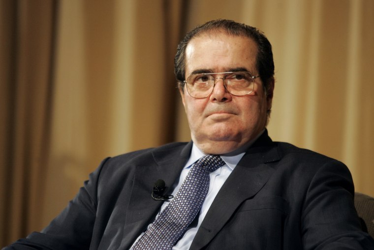 Image: Supreme Court Justice Antonin Scalia pauses during a conversation