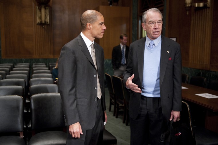 Paul Watford, nominee to be U.S. circuit judge for the Ninth Circuit, speaks with Sen. Chuck Grassley, R-Iowa, on Tuesday, Dec. 13, 2011.