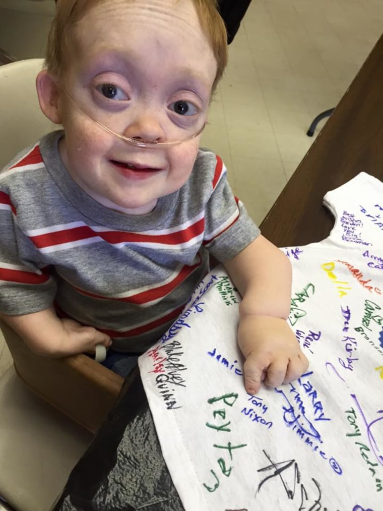 boy with dwarfism gives back