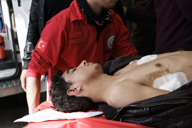 Image: Turkish medics carry a wounded Syrian to a hospital in Kilis, Turkey after bombing in Northern Syria