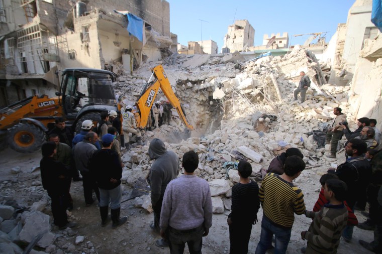 Image: Civil defence members search for survivors after airstrikes by pro-Syrian government forces in the rebel held al-Qaterji neighbourhood of Aleppo