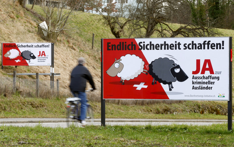 Image: Swiss People's Party posters are displayed beside a road in Adliswil, Switzerland