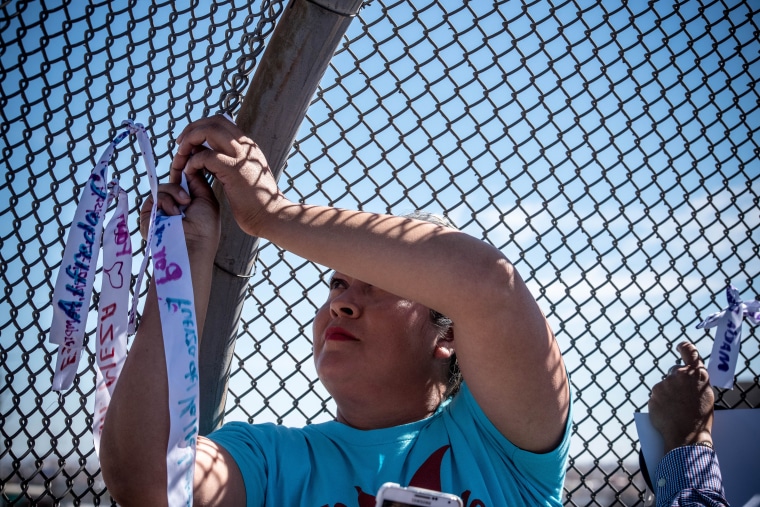 As they made their way across the border, the women stopped to tie ribbons with names of immigrants on barbed wire fences.