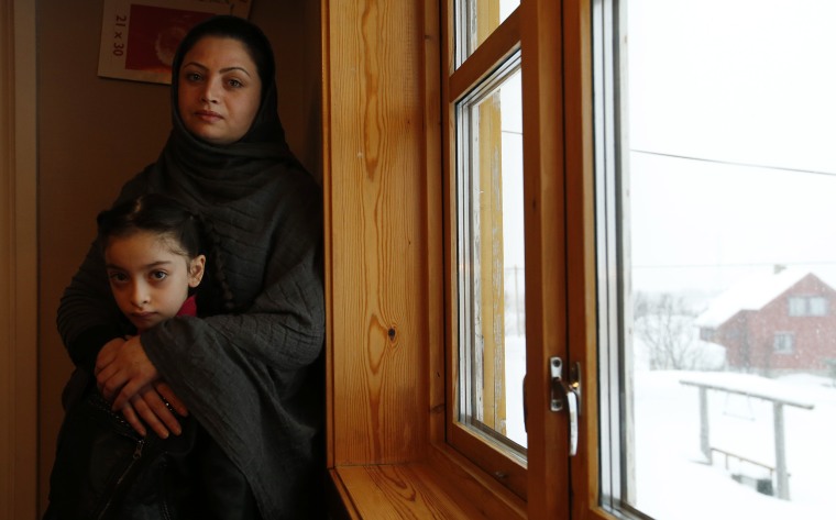 Image: Afghan asylum seekers Sufya Nawabi, her daughter Helanar, pose for a photograph in her temporary apartment