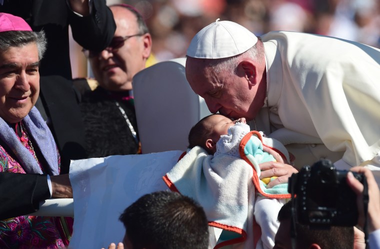 Image: Pope Francis kisses a newborn upon arriving in Ciudad Juarez