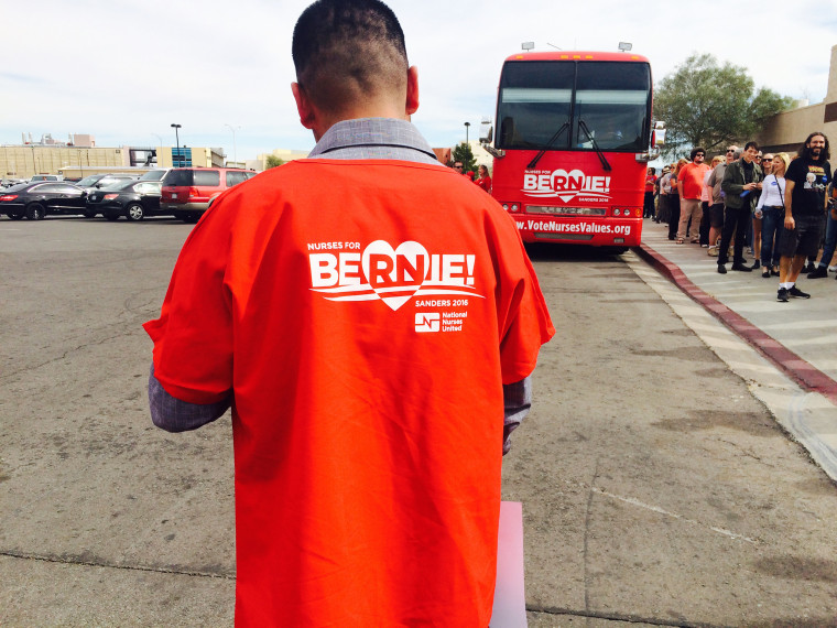 A Bernie Sanders supporter with a nurse’s union stands near a bus parked outside a high school where Bernie Sanders held a rally in Las Vegas this week.