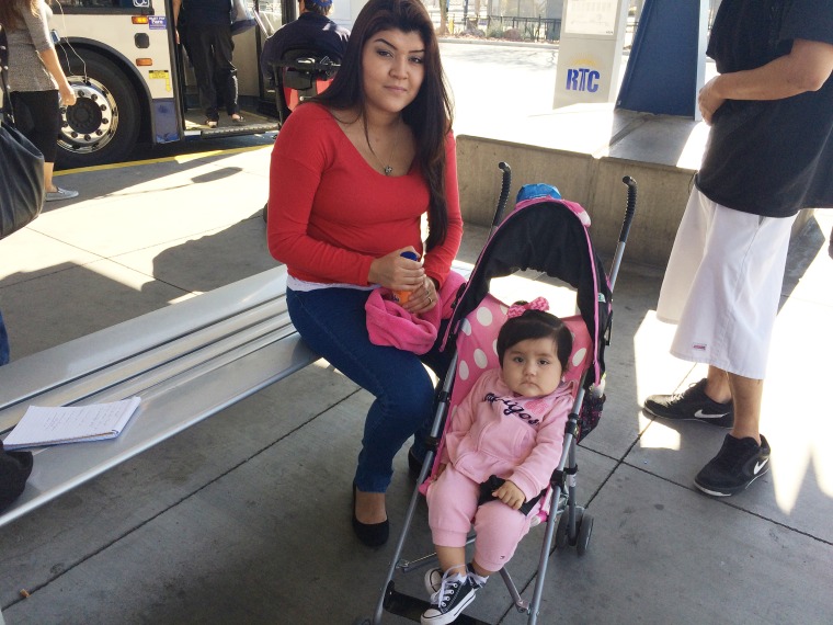 Jasmine Cueto, 21, sits with her daughter Anaya at a bus stop in Las Vegas. She said she¹s too turned off by the election rhetoric to vote.