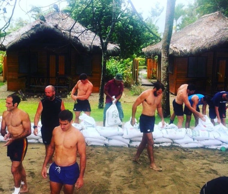 Spain's Ruby Sevens team assisting a local resort in Fiji with storm preparations.
