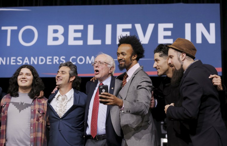 Image: U.S. Democratic presidential candidate Bernie Sanders sings on stage with performers at a campaign rally in Henderson